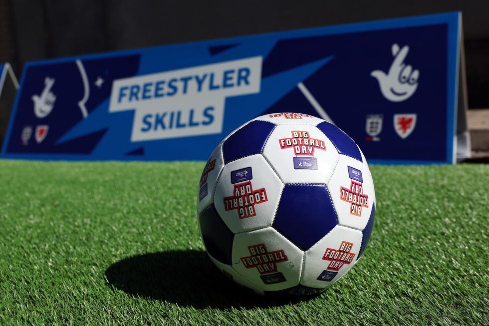 Football with National Lottery logo as part of a community charity event
