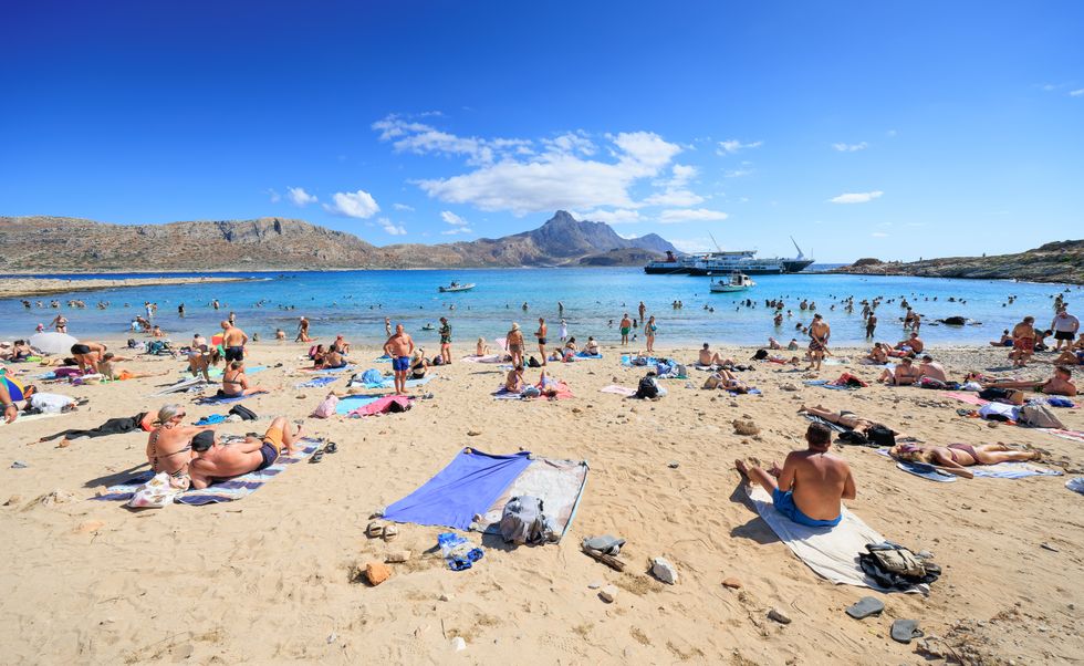 Holidaymakers sunbathing on the Greek island of Crete
